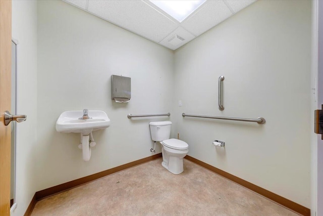 bathroom featuring toilet and a paneled ceiling