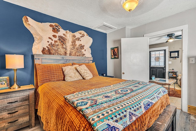 bedroom featuring hardwood / wood-style floors and a textured ceiling