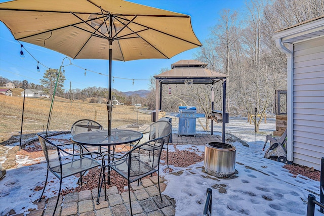 view of patio / terrace with a gazebo, a grill, and a mountain view