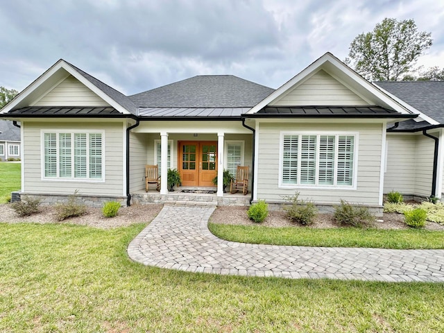 view of front of house with a porch and a front lawn