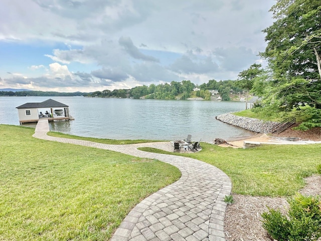 property view of water with a fire pit and a boat dock