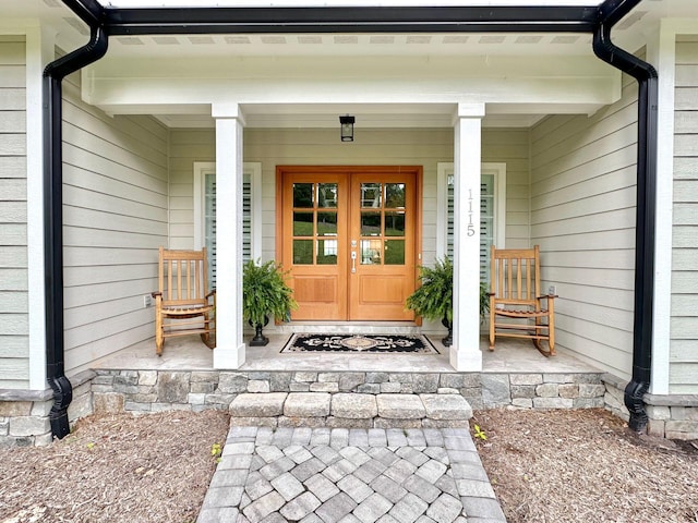 entrance to property featuring french doors and a porch