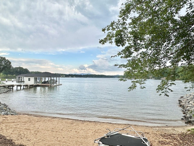 dock area featuring a beach view and a water view