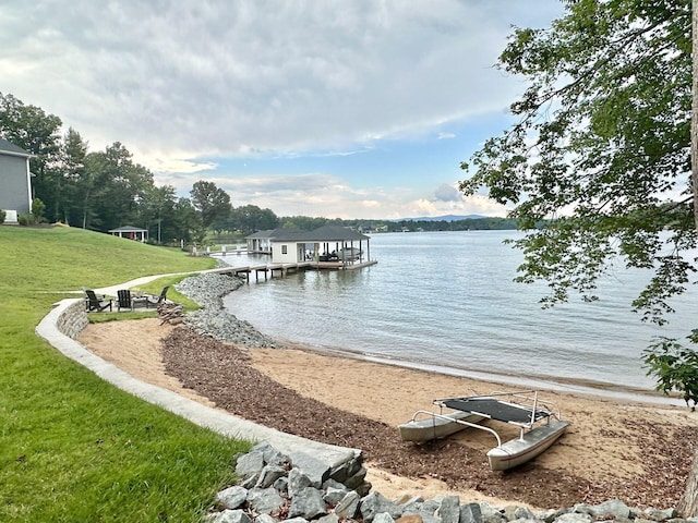 view of dock featuring a water view and a lawn