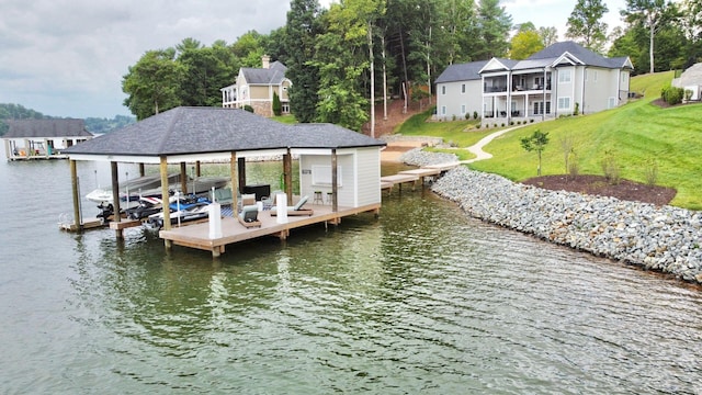 view of dock featuring a lawn and a water view