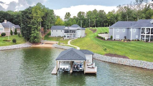 dock area with a lawn and a water view