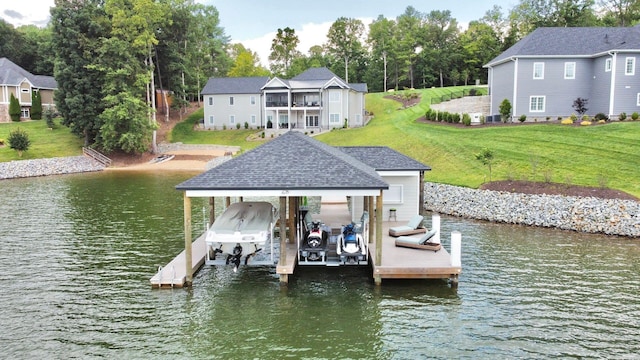 view of dock with a water view and a lawn