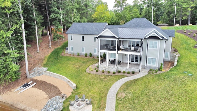 rear view of property featuring a patio and a yard