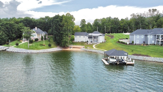 view of dock featuring a water view and a yard