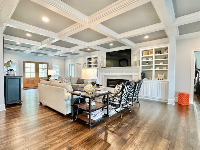 living room with dark wood-type flooring, ornamental molding, beam ceiling, and french doors