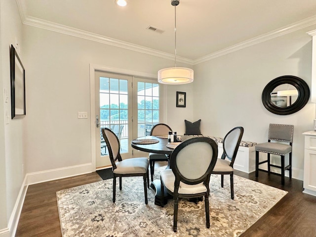 dining area with dark hardwood / wood-style floors and ornamental molding
