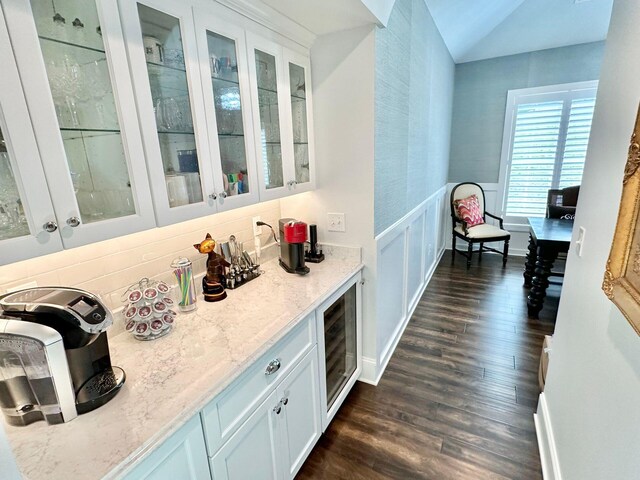 bar featuring light stone countertops, white cabinets, dark hardwood / wood-style floors, and wine cooler