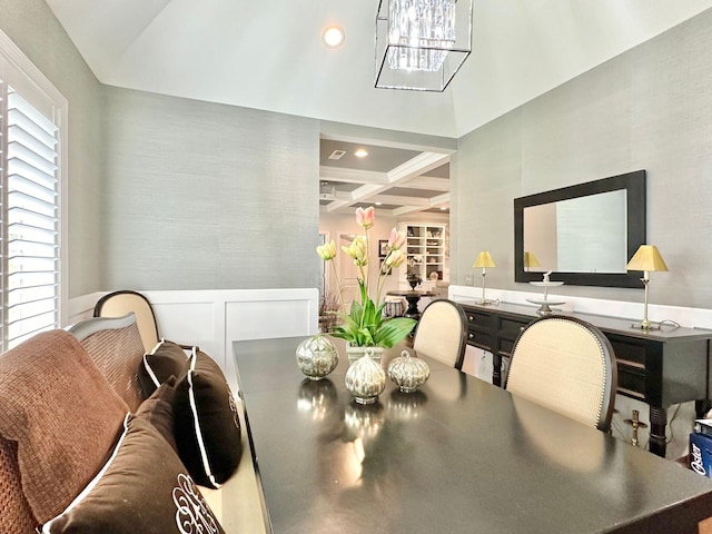 dining area with a notable chandelier, coffered ceiling, and beamed ceiling