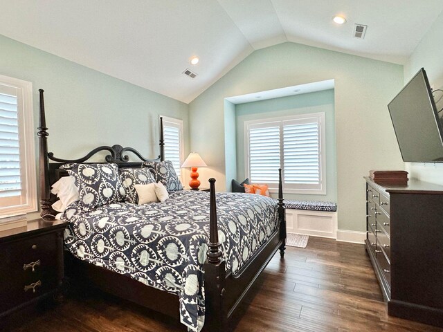 bedroom with dark hardwood / wood-style floors and lofted ceiling