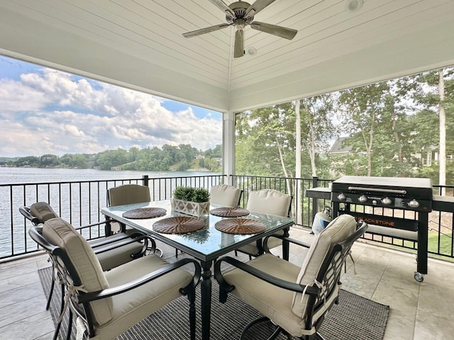 view of patio / terrace featuring ceiling fan and a water view