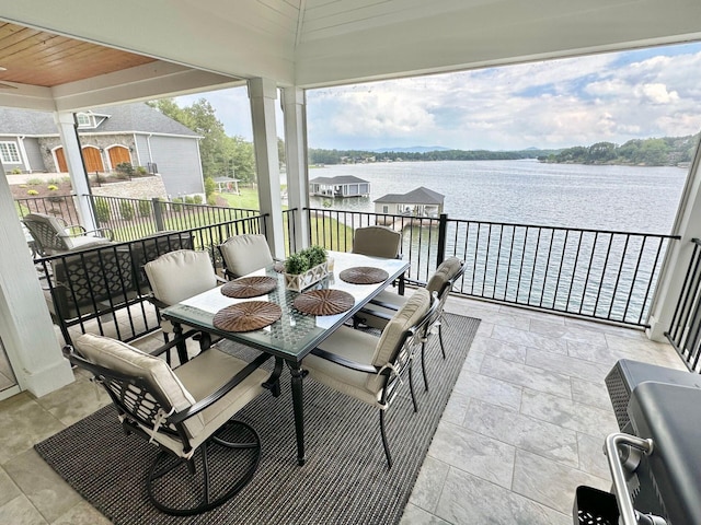 sunroom / solarium with a water view