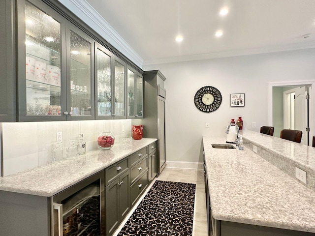 bar with light stone counters, sink, and wine cooler