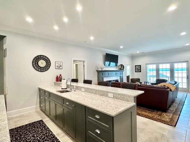 kitchen featuring sink, light stone countertops, and ornamental molding