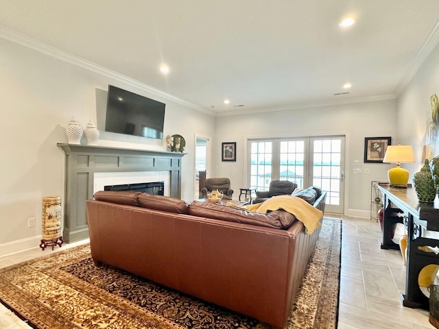 living room with a tile fireplace and crown molding