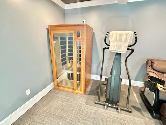 workout area featuring crown molding