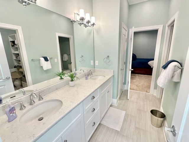 bathroom featuring vanity, toilet, and a notable chandelier