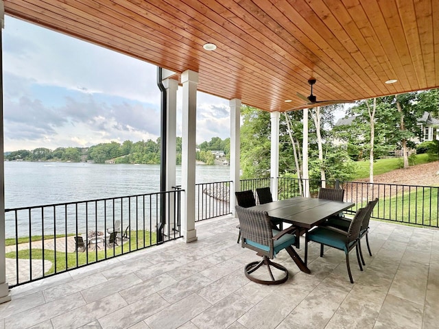 view of patio / terrace featuring ceiling fan and a water view