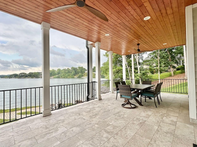 view of patio / terrace with ceiling fan and a water view