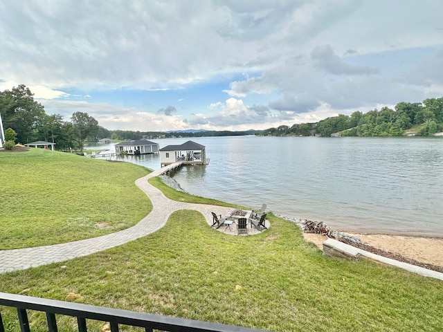 dock area featuring a water view and a yard