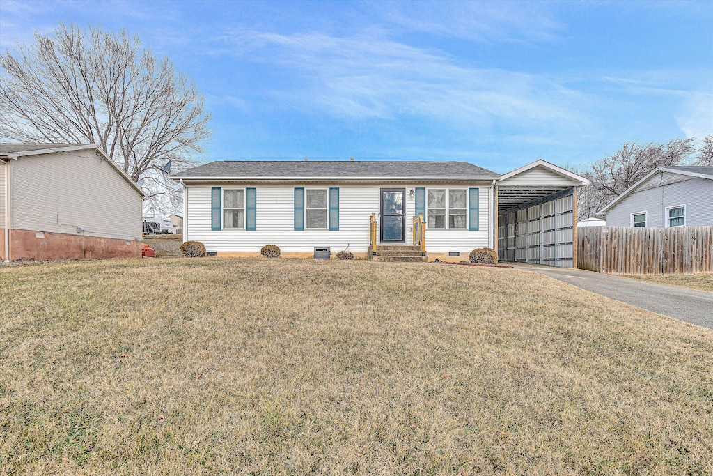 view of front of home with a front yard and a carport