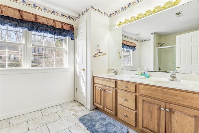 bathroom featuring tile patterned flooring, a shower with door, and vanity