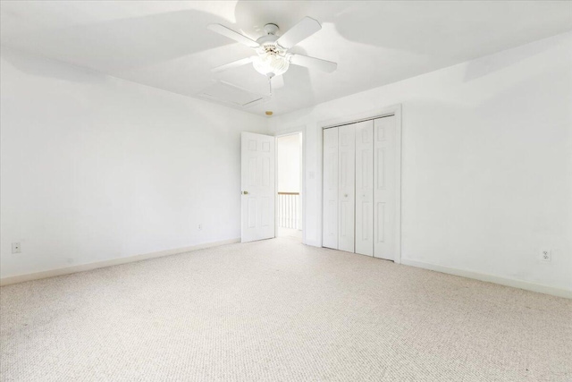 unfurnished bedroom featuring ceiling fan, carpet, and a closet