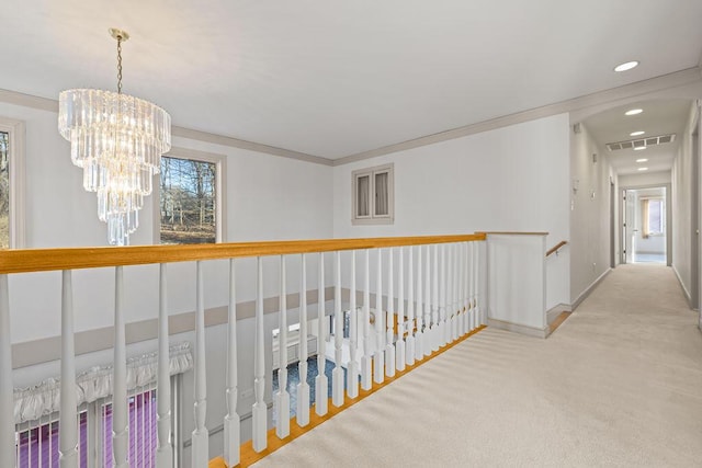 hallway with light carpet, a chandelier, a wealth of natural light, and crown molding