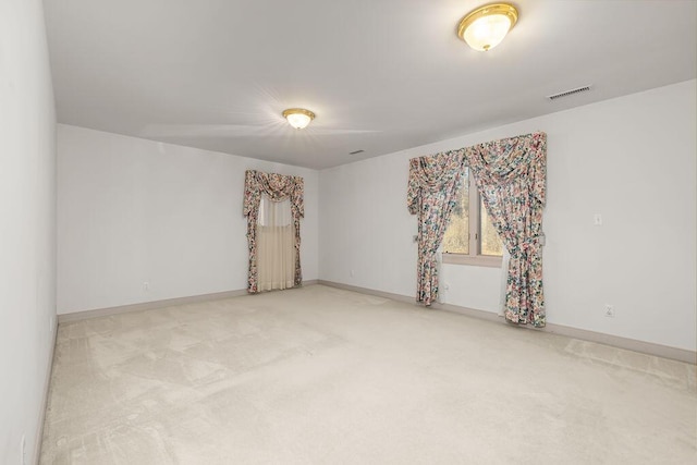 unfurnished room with light colored carpet