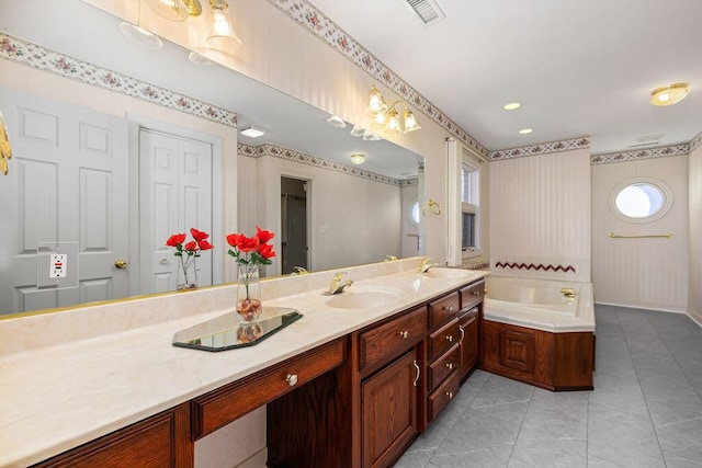 bathroom featuring a bath, tile patterned floors, and vanity