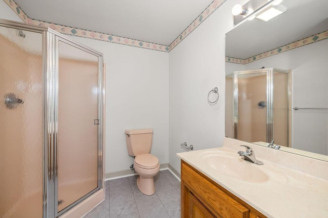 bathroom with a shower with door, toilet, tile patterned floors, and vanity