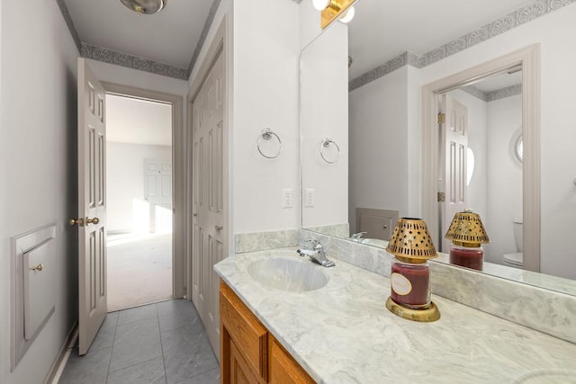 bathroom with vanity, toilet, and tile patterned flooring