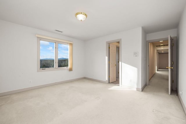 unfurnished room with light carpet