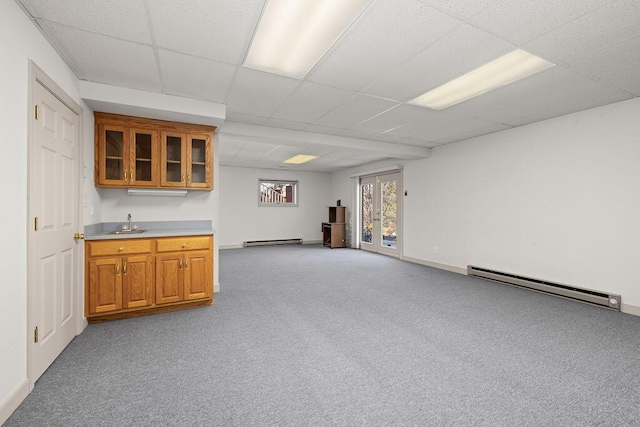 interior space featuring a baseboard radiator, sink, a paneled ceiling, and light carpet