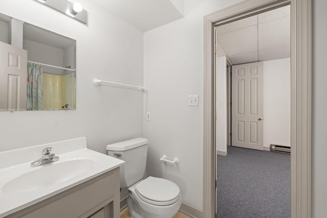 bathroom with a baseboard heating unit, walk in shower, toilet, and vanity