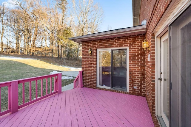 wooden terrace featuring a lawn