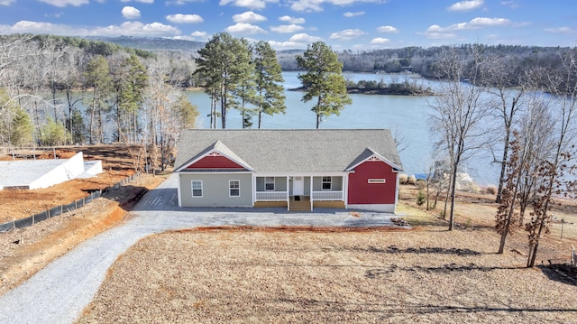 ranch-style house featuring a porch and a water view