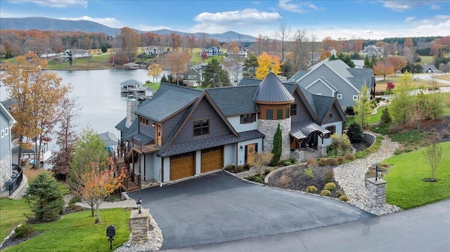 drone / aerial view featuring a water and mountain view