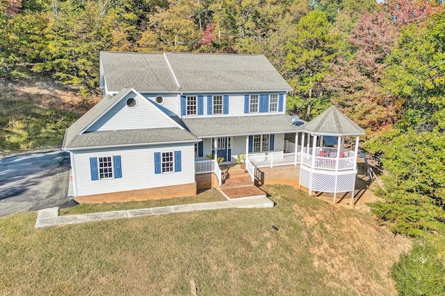 view of front facade with a porch and a front lawn