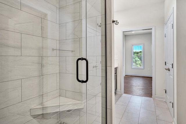 full bath featuring a shower stall, baseboards, and vanity