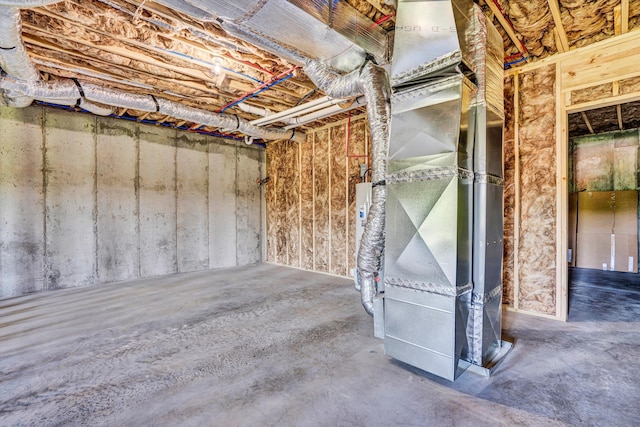 unfinished basement featuring heating unit
