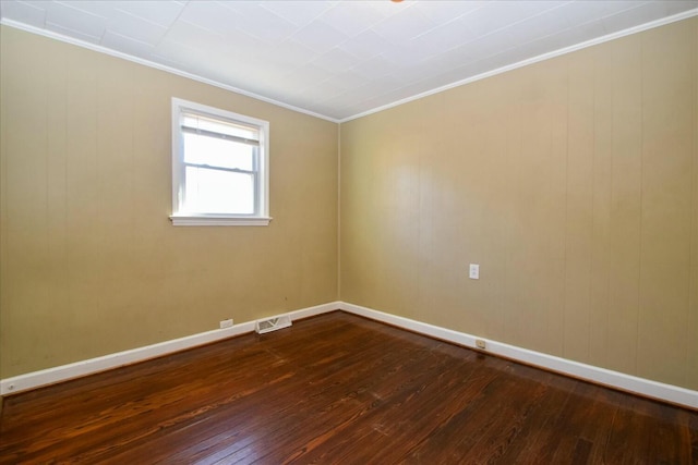 empty room with ornamental molding and wood-type flooring