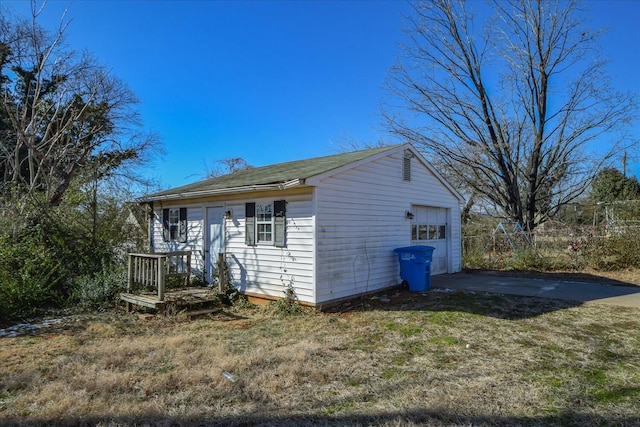 view of front facade with an outbuilding and a garage