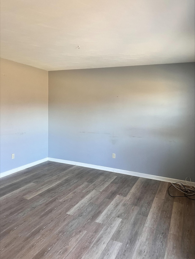 unfurnished room featuring dark hardwood / wood-style flooring