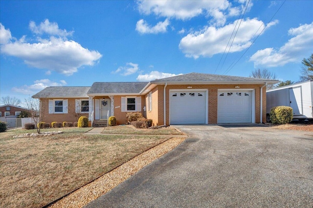 single story home featuring a garage and a front lawn