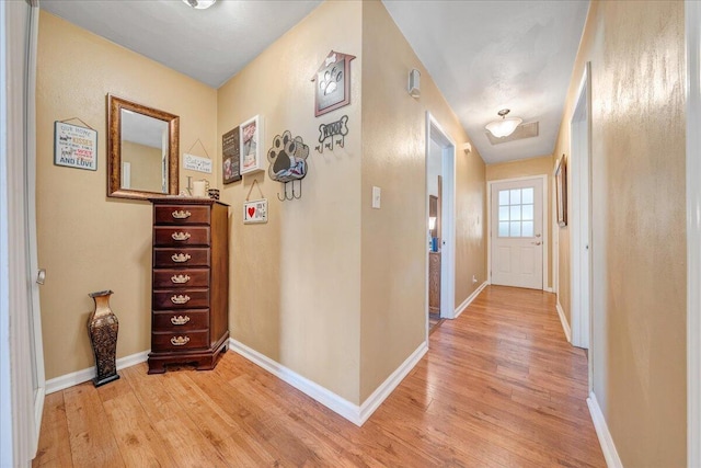 corridor with light hardwood / wood-style flooring